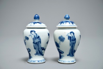 A pair of Chinese blue and white miniature vases and covers or tea caddies, Kangxi