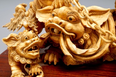 A Chinese carved ivory group of Buddhist lions playing with a ball, 19/20th C.