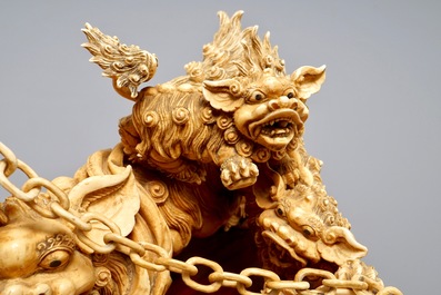 A Chinese carved ivory group of Buddhist lions playing with a ball, 19/20th C.