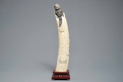 A tall Chinese carved ivory figure of a lady, 2nd half 19th C.