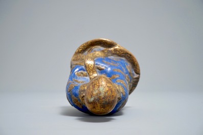 A Chinese champlev&eacute; enamel and gilt copper model of a Luohan, Qianlong