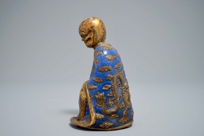 A Chinese champlev&eacute; enamel and gilt copper model of a Luohan, Qianlong