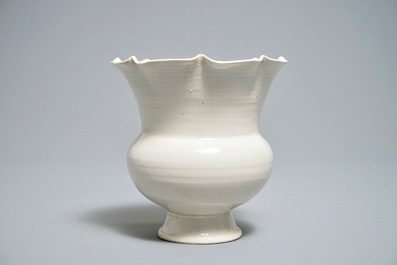 A Chinese foliate-rimmed cream-glazed dingyao bowl on foot, Song or later