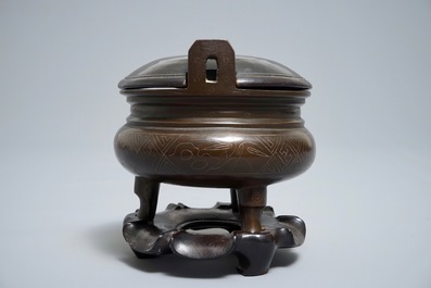 A Chinese silver-inlaid bronze incense burner on stand, 19th C.