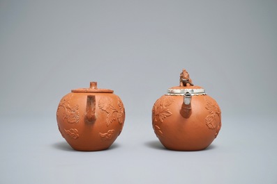 Two Chinese Yixing stoneware teapots with applied floral design, Kangxi