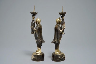 A pair of Chinese bronze 'Hehe Er Xian brothers' candlesticks, 19/20th C.