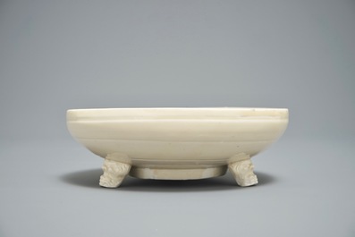 A Chinese monochrome cream-glazed vase and a tripod censer, Ming