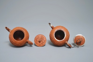 Two Chinese Yixing stoneware teapots with applied floral design, Kangxi