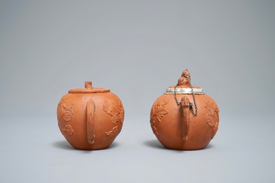 Two Chinese Yixing stoneware teapots with applied floral design, Kangxi