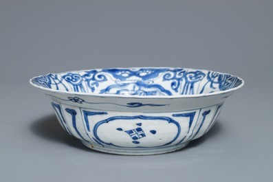 A Chinese blue and white kraak porcelain klapmuts bowl with a flower basket, Wanli