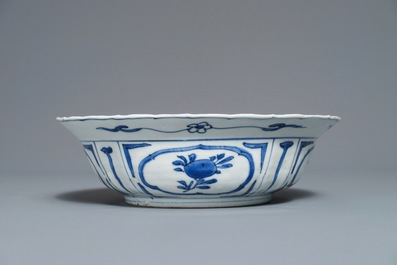 A Chinese blue and white kraak porcelain klapmuts bowl with a flower basket, Wanli