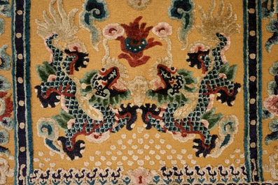 A Chinese silk and gilt-thread 'five dragon' carpet with inscription, 19th C.