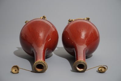 A pair of Chinese gilt bronze-mounted oxblood-glazed vases, 19th C.