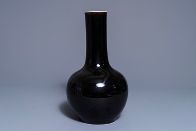 A Chinese mirror-black-glazed bottle vase, Kangxi mark, 19th C.