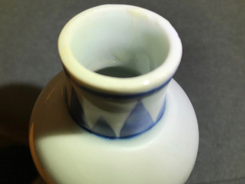 A Chinese blue and white bottle vase with floral design, Transitional period