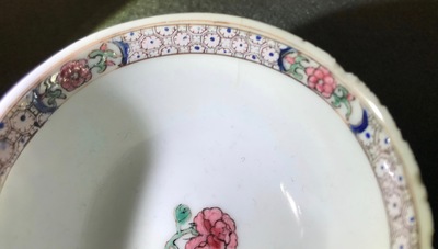 A Chinese famille rose cup and saucer depicting Lie Ti Guai with three goats, Yongzheng