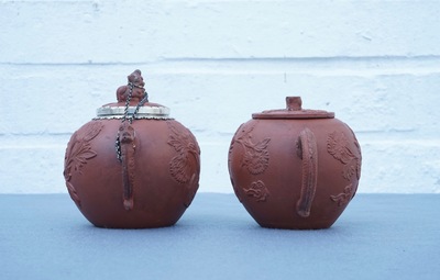 Two Chinese Yixing stoneware teapots with applied floral design, Kangxi