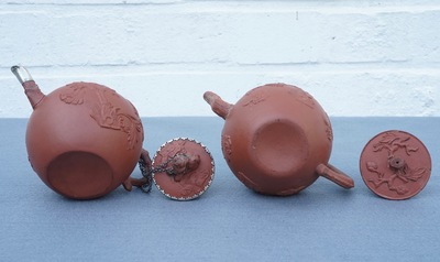 Two Chinese Yixing stoneware teapots with applied floral design, Kangxi