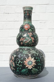 A Chinese black-ground famille verte double gourd dragon vase, 19th C.