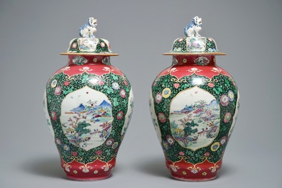 A pair of Chinese famille rose black-ground vases and covers, Yongzheng