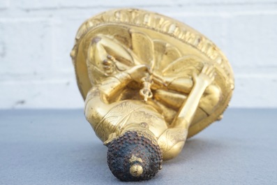 A Tibetan gilt bronze figure of Buddha with vajra, 19th C.