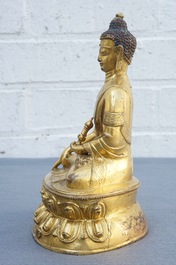 A Tibetan gilt bronze figure of Buddha with vajra, 19th C.