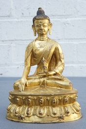 A Tibetan gilt bronze figure of Buddha with vajra, 19th C.