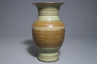 A Chinese archaistic celadon-glazed vase with moulded design, 19th C.