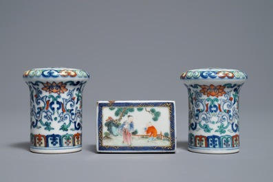 A pair of Chinese doucai scroll ends and a famille rose paper weight, 19/20th C.