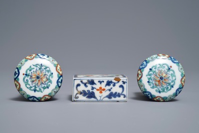 A pair of Chinese doucai scroll ends and a famille rose paper weight, 19/20th C.