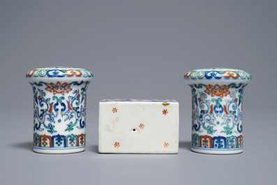 A pair of Chinese doucai scroll ends and a famille rose paper weight, 19/20th C.