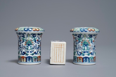 A pair of Chinese doucai scroll ends and a famille rose paper weight, 19/20th C.