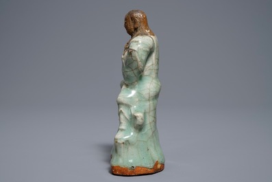 Een Chinese Longquan celadon en biscuit figuur van Zhenwu, Ming