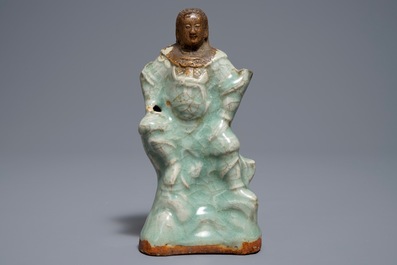 Een Chinese Longquan celadon en biscuit figuur van Zhenwu, Ming