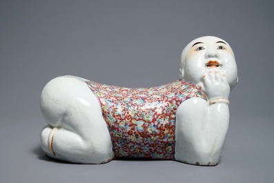 A Chinese famille rose headrest in the shape of a boy, Republic, early 20th C.