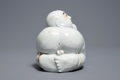 A Chinese famille rose headrest in the shape of a boy, Republic, early 20th C.