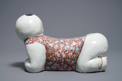 A Chinese famille rose headrest in the shape of a boy, Republic, early 20th C.