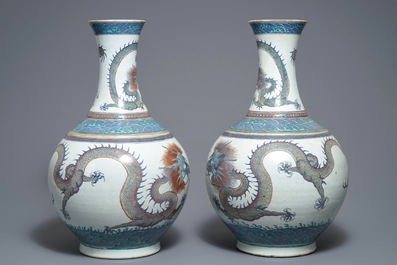 A pair of large Chinese doucai 'dragon' bottle vases, tianqiu ping, Qianlong mark, 19th C.