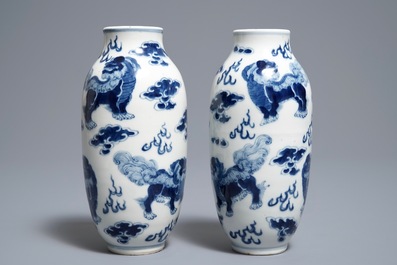 A pair of Chinese blue and white 'buddhist lions' vases, Kangxi mark, 19th C.