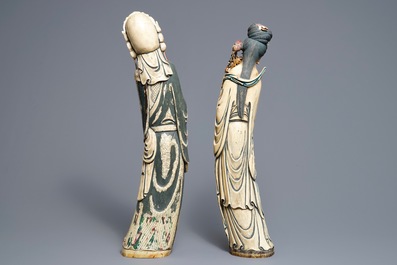 A pair of tall Chinese polychrome ivory figures on wooden bases, 19th C.