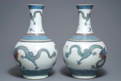 A pair of large Chinese doucai 'dragon' bottle vases, tianqiu ping, Qianlong mark, 19th C.