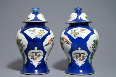 A pair of Chinese famille verte blue ground vases and covers, 19th C.