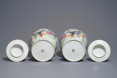 A pair of Chinese famille rose vases and covers, Qianlong mark, 20th C.