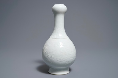 A Chinese blanc de Chine vase with underglaze dragon design, Qianlong mark, 19/20th C.