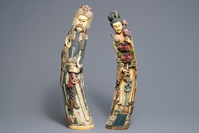 A pair of tall Chinese polychrome ivory figures on wooden bases, 19th C.