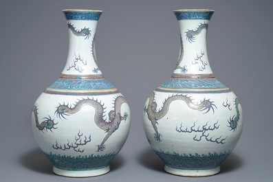 A pair of large Chinese doucai 'dragon' bottle vases, tianqiu ping, Qianlong mark, 19th C.