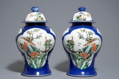 A pair of Chinese famille verte blue ground vases and covers, 19th C.