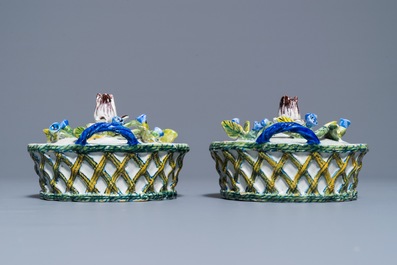 A pair of polychrome Dutch Delft butter tubs with applied design on reticulated stands, 18th C.