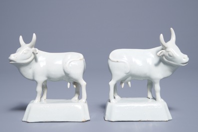 A pair of white Dutch Delft models of cows on bases, 18th C.