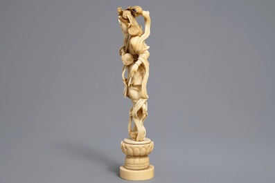 A Japanese carved ivory figure of a lady with a drum on a lotus throne, Meiji, 19th C.